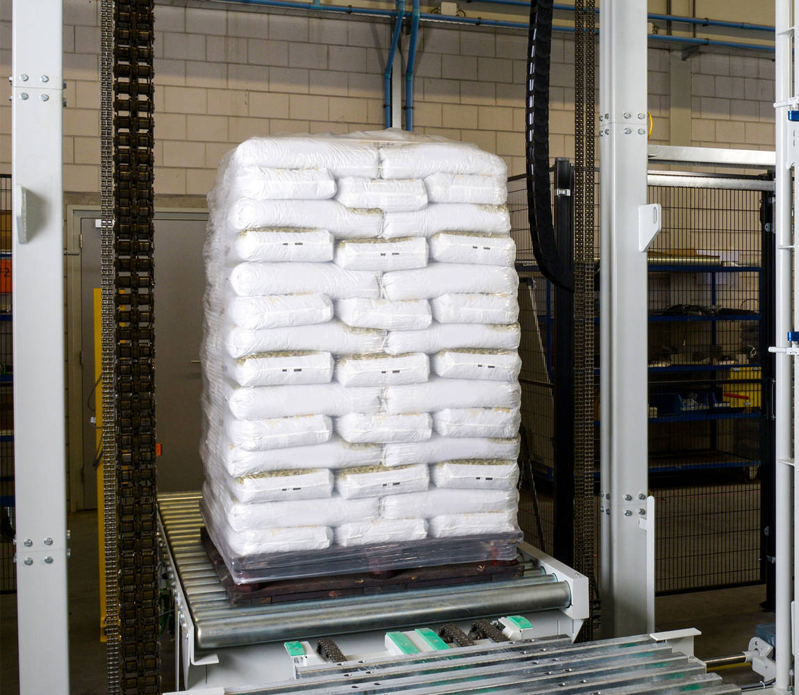 A pallet filled with bags is protected by a stretch hood