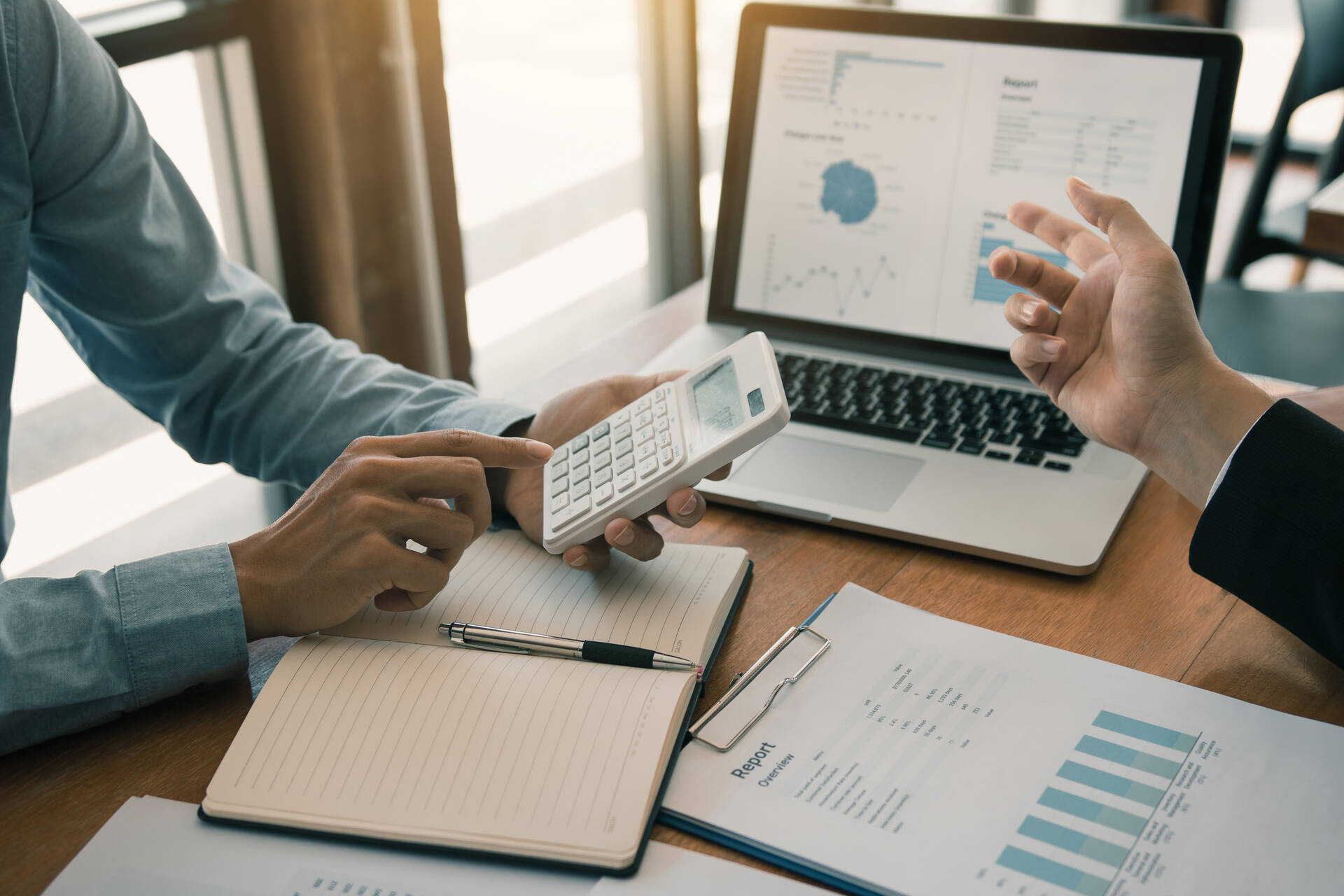 People calculating financial results and costs