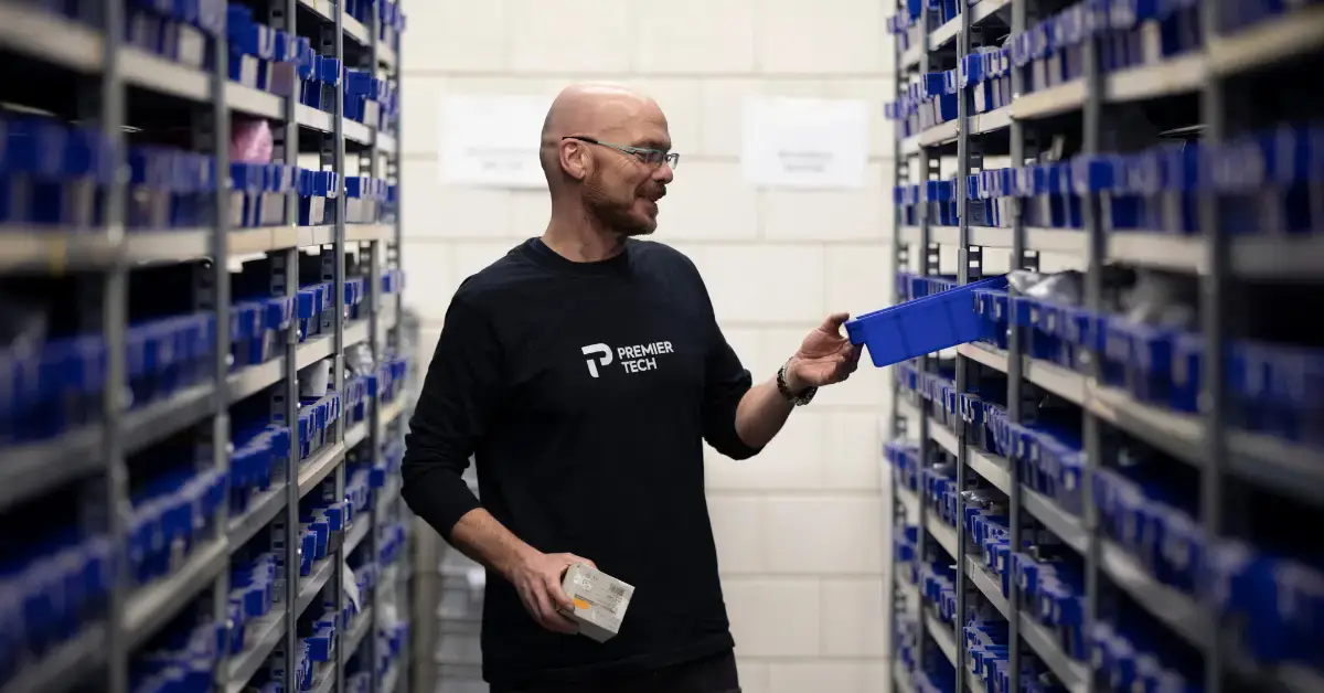 Premier Tech parts specialist searching for a component in the spare parts storage room