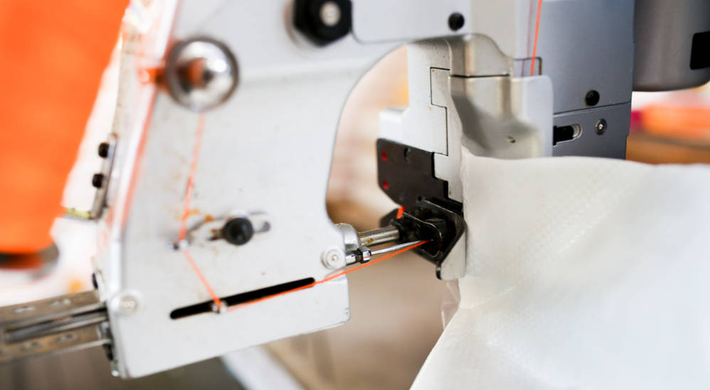 A bag sewing machine in action