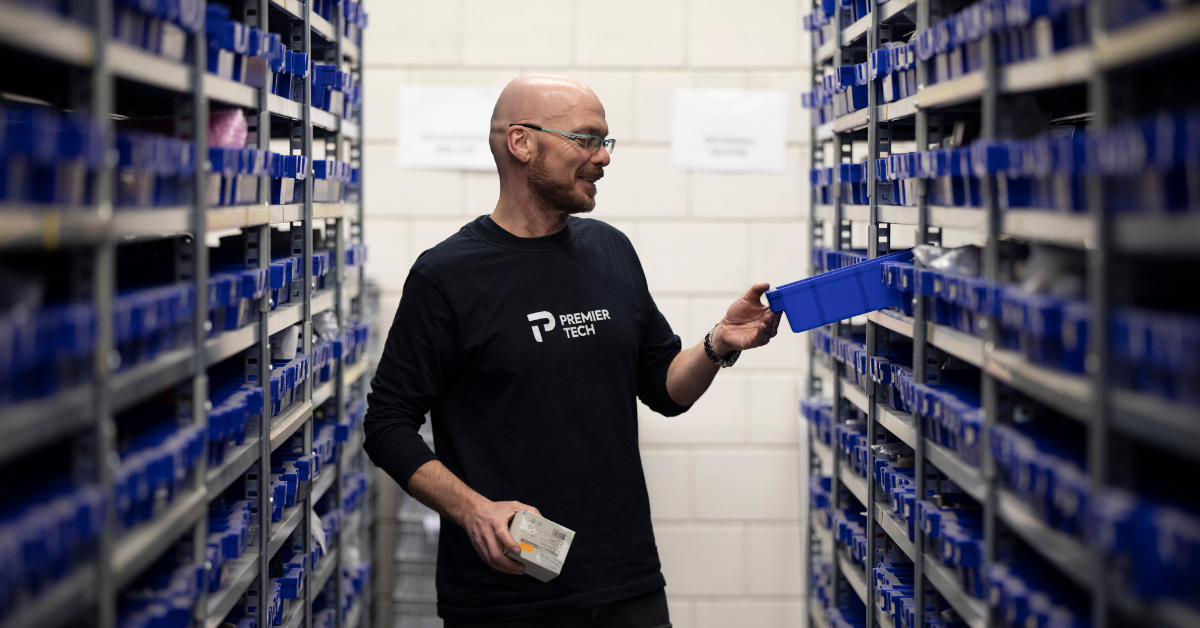 Premier Tech parts specialist searching for a component in the spare parts storage room