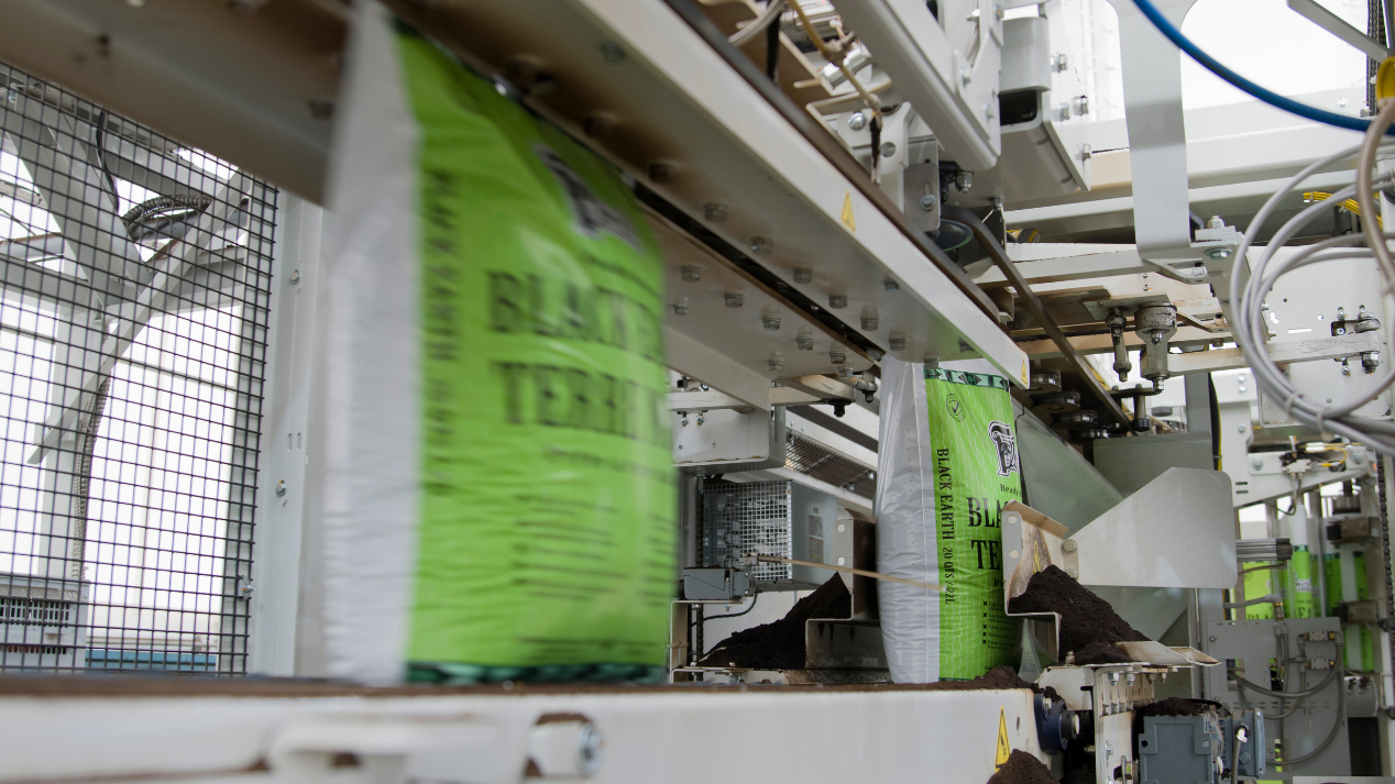 Growing media bags being automatically filled and sealed on a packaging line