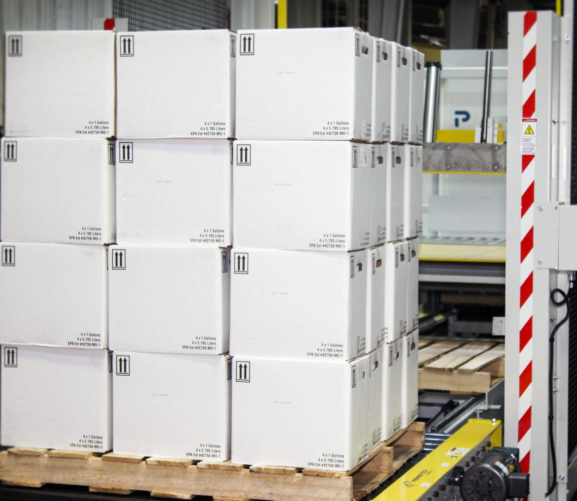 A pallet load of boxes exit a low-level palletizer