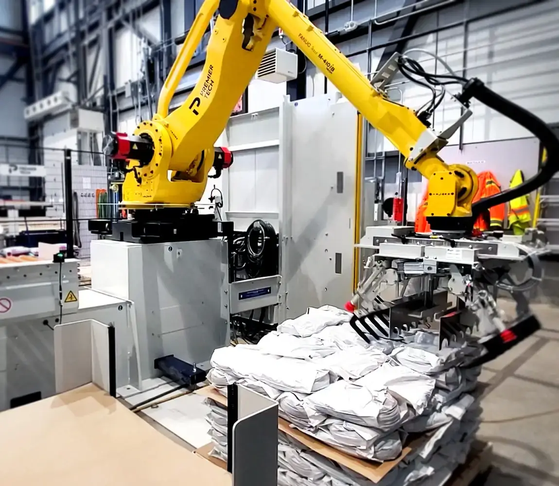 Robot palletizer stacks bags on a pallet