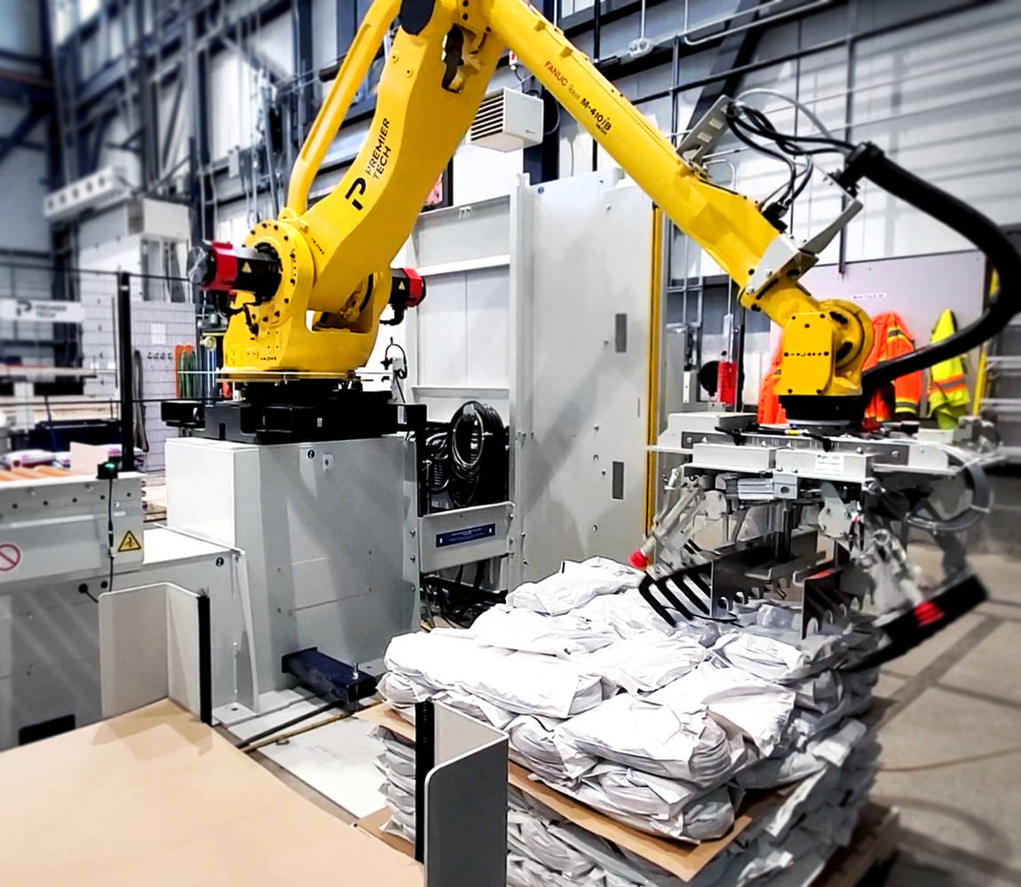 Robot palletizer stacks bags on a pallet