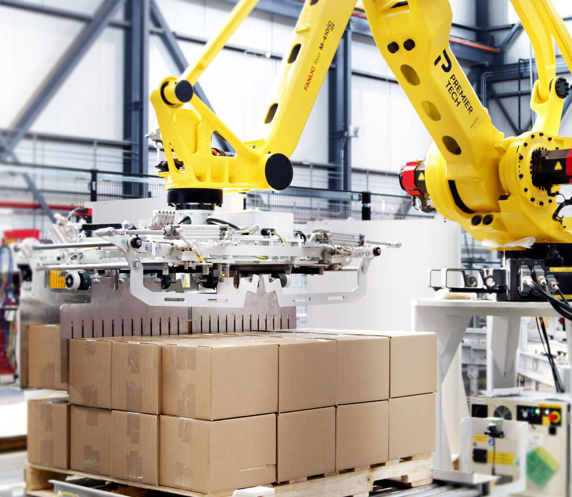 Robotic palletizer stacking a row of cases on a pallet