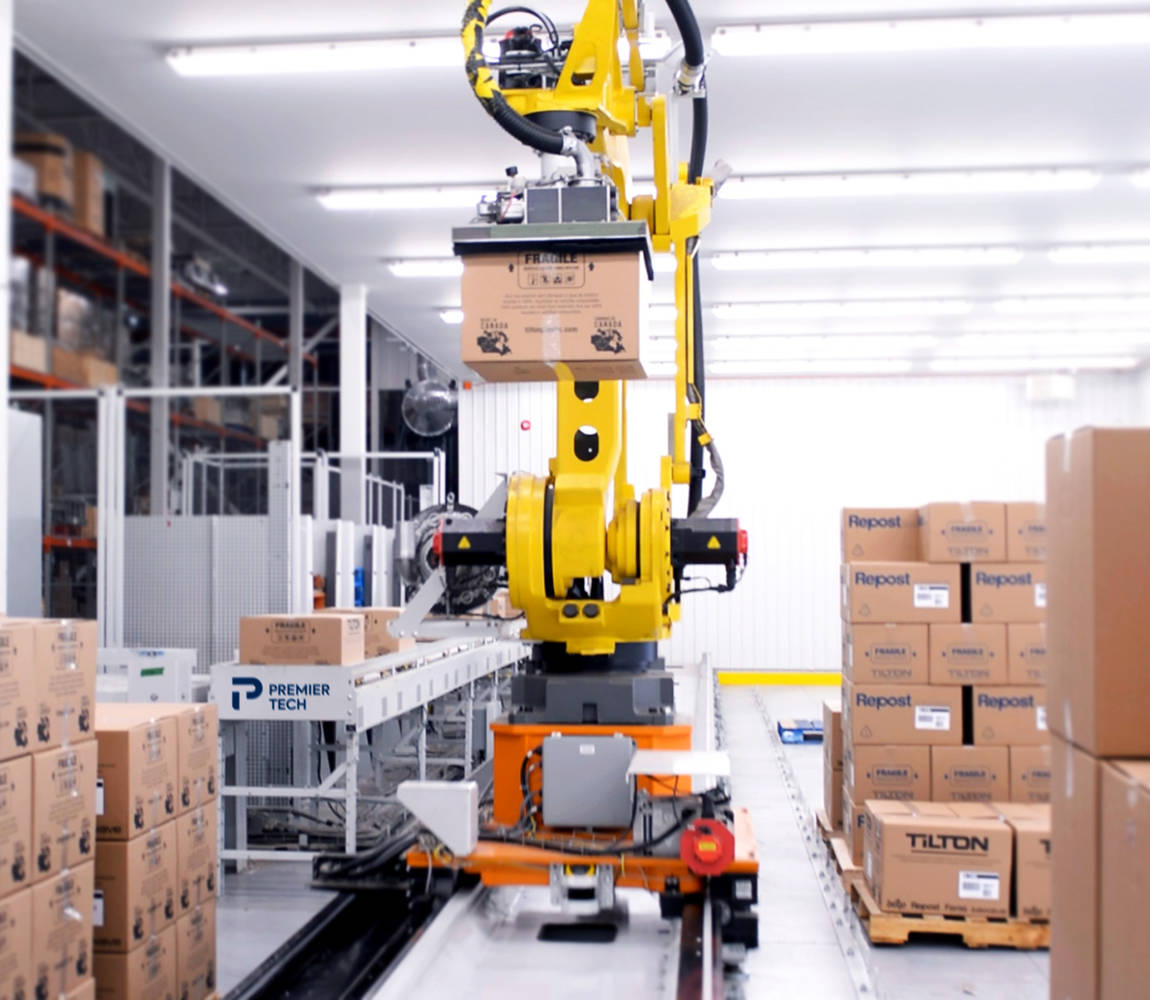 Robot palletizer on rails handling a carton box