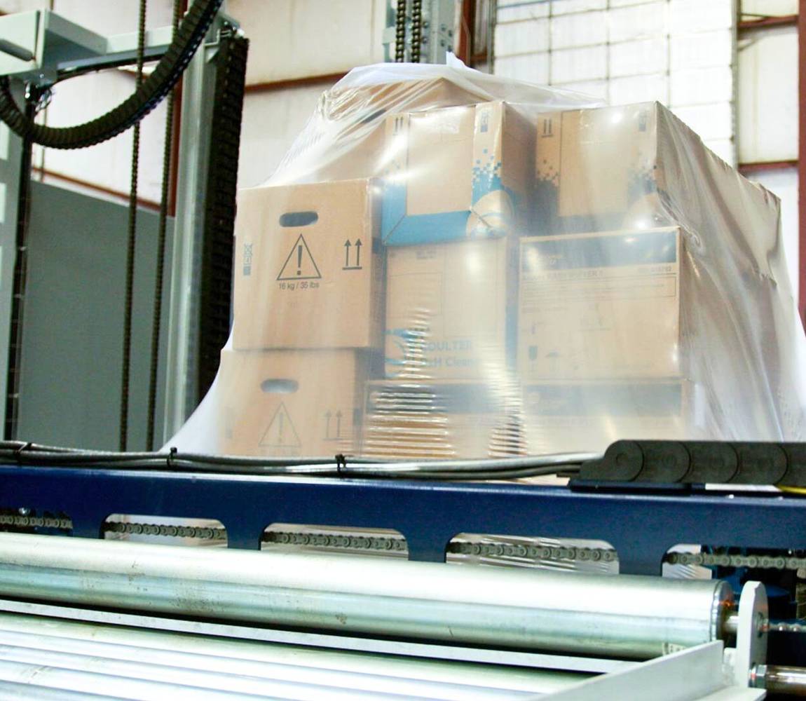 Stretch hooder hooding a pallet of mixed boxes