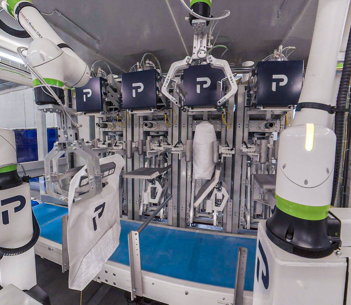 Air valve bagging machine with four spouts close up filling bags with product