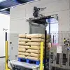 A pallet load of flour bags exits a conventional palletizer
