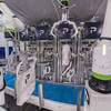 Air valve bagging machine with four spouts close up filling bags with product