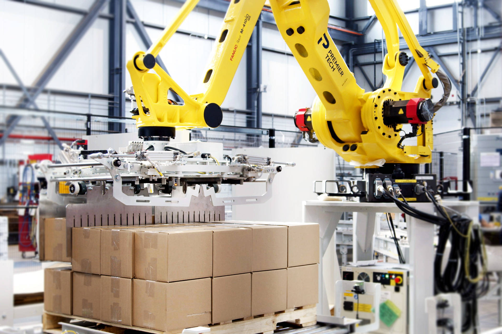 Robotic palletizer stacking a row of cases on a pallet