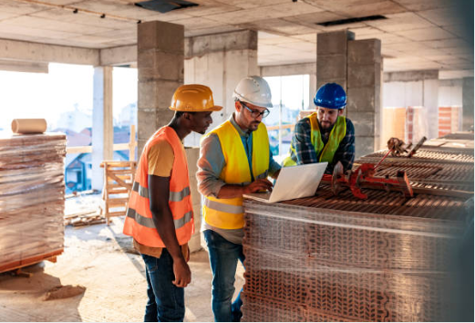 Construction workers looking at building designs