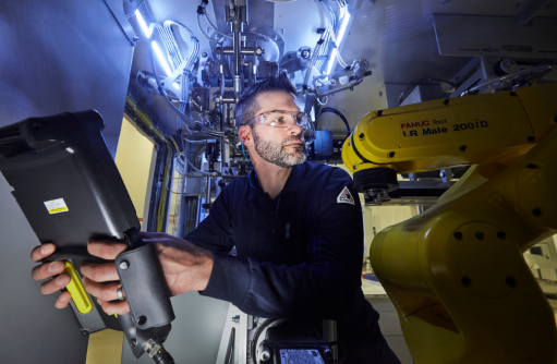 Service technician conducting management on a robotic palletizer