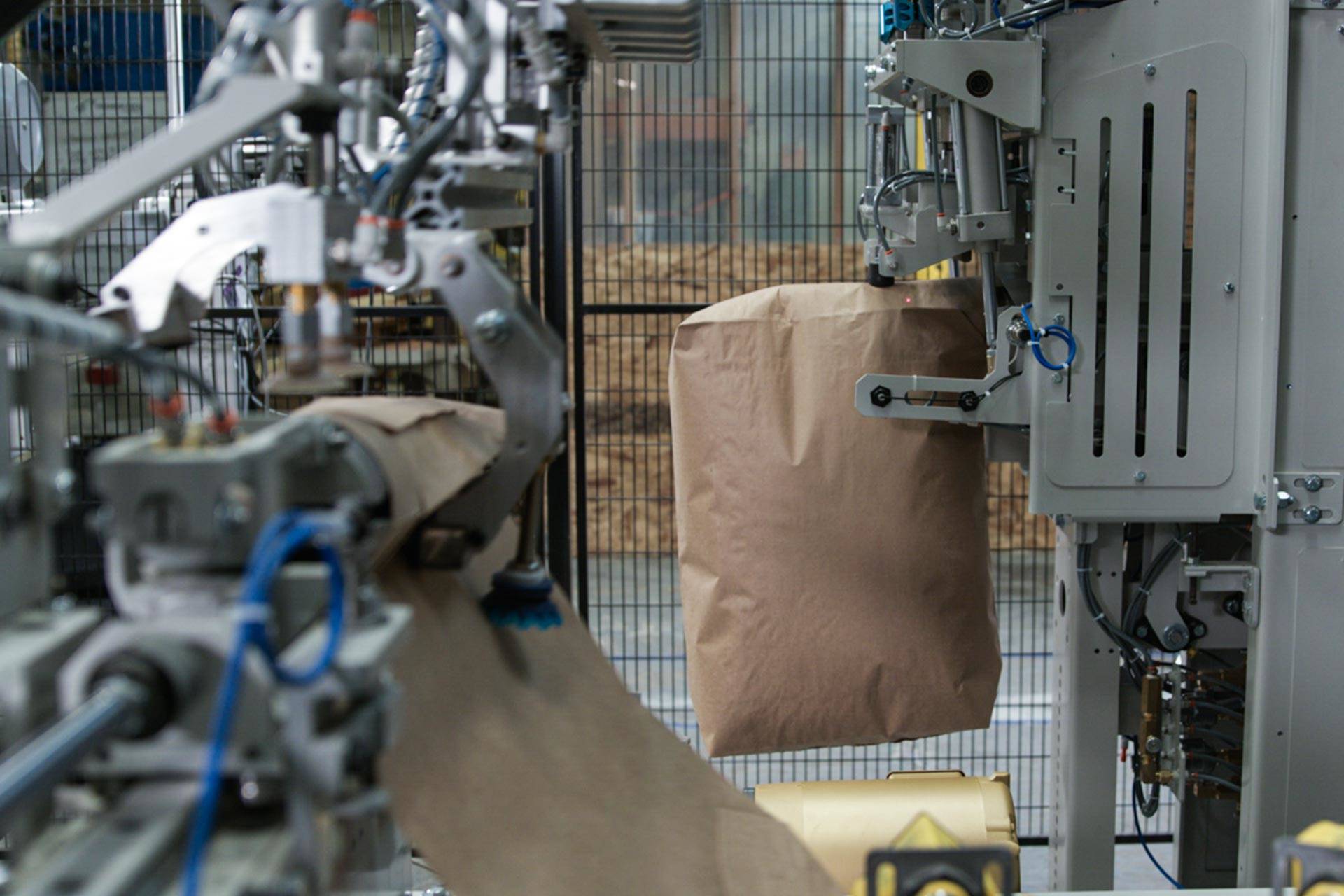Valve bagger apply and stack bag spout
