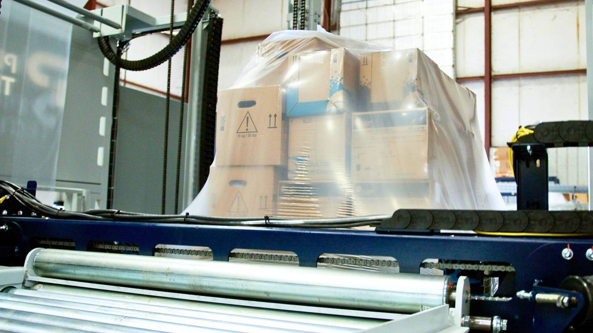 Stretch hooder hooding a pallet of mixed boxes