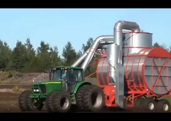 Tractor carrying Premier Tech vacuum harvester